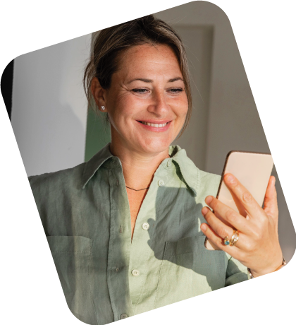 A person entering a passcode on a locked smartphone while using a laptop.